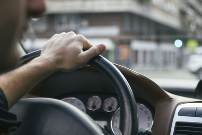 Midsection of man driving car