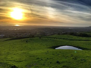 Scenic view of field against sky during sunset