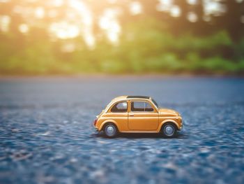 Yellow toy car on road