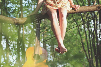 Woman standing on tree trunk