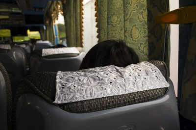 Rear view of woman sitting in chair