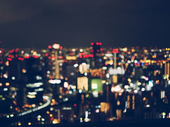 Defocused image of illuminated city at night