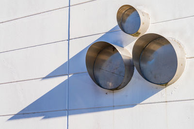 Low angle view of light fixture on tiled wall