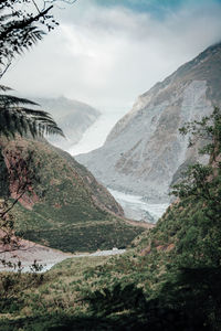 Scenic view of mountains against cloudy sky