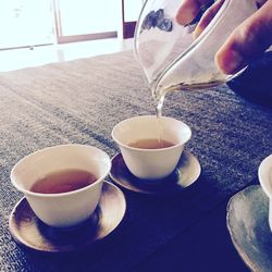 Close-up of man with tea cup on table