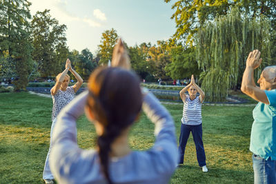 Group of people doing tai chi in a park