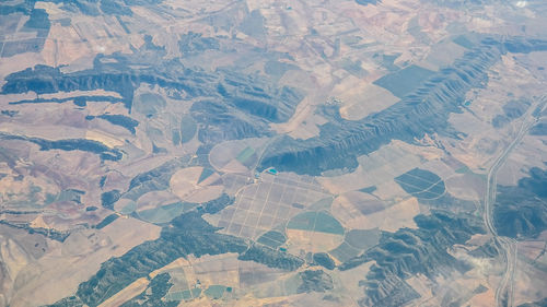 Full frame shot of airplane flying over agricultural field