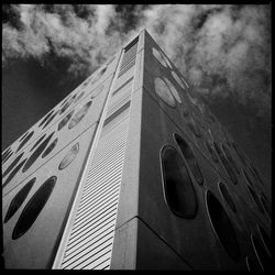 Low angle view of building against cloudy sky