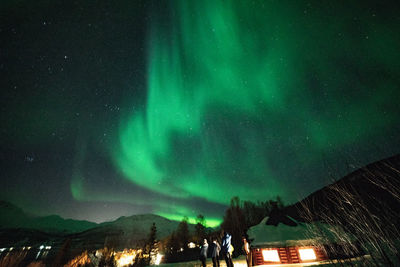 Low angle view of illuminated mountain against sky at night