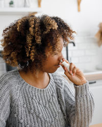 Portrait of young woman drinking water