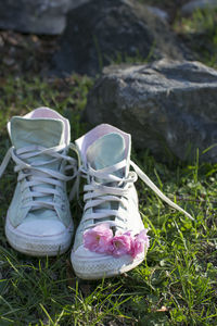 Close-up of shoes on grass