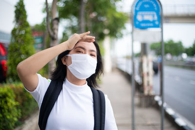 Portrait of a person standing on a road