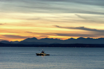 Ship at sunset over puget sound and the olympic mountains.