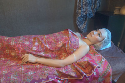 Young woman lying on massage table