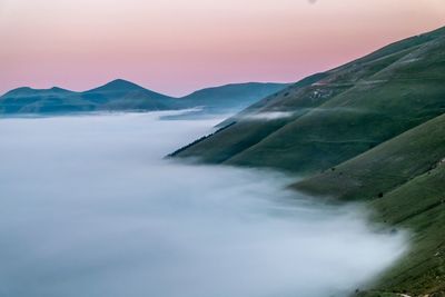 Scenic view of mountains against sky during foggy weather