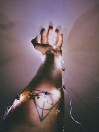 Close-up of woman hand on glass of water