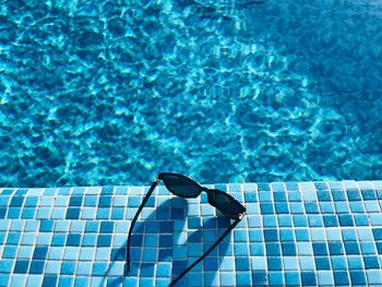 High angle view of sunglasses at poolside