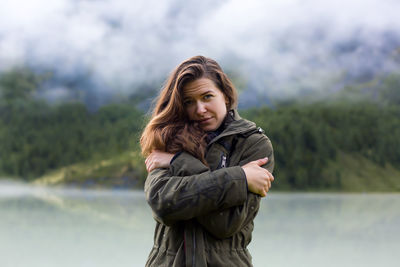 Portrait of smiling woman standing in winter