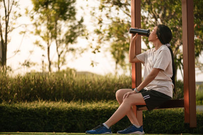 Full length of woman exercising in park