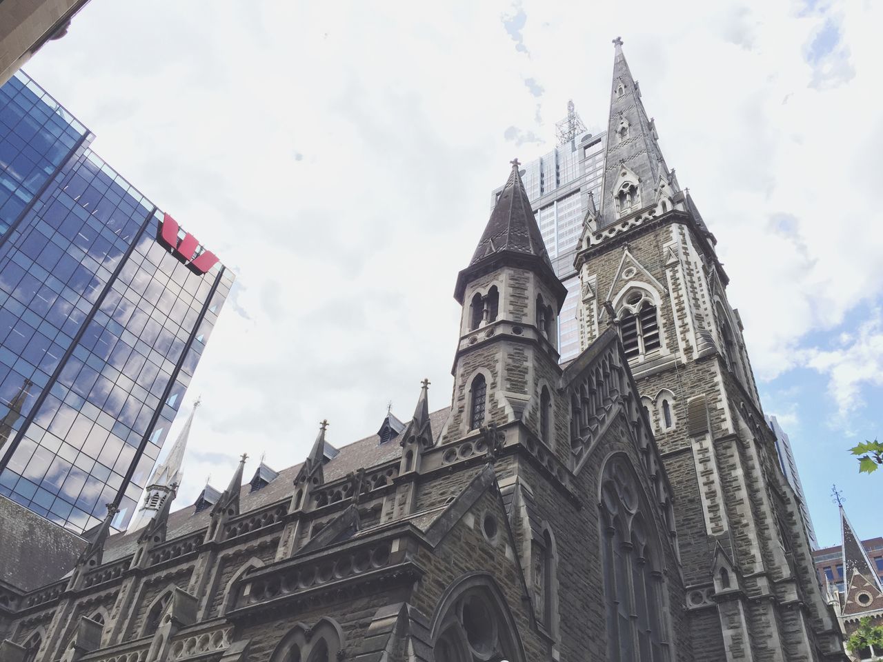 building exterior, architecture, built structure, low angle view, place of worship, no people, sky, religion, spirituality, day, travel destinations, outdoors, city, rose window