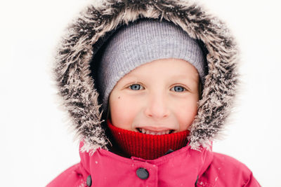 Close-up portrait of girl wearing warm clothing during winter