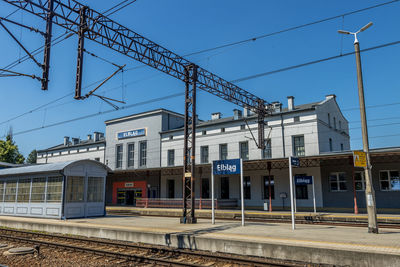 Railroad station platform against clear sky, train station in elblag, poland.