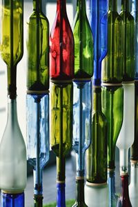 Close-up of wine bottles in glass for sale