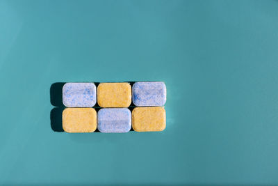 Directly above shot of multi colored toy blocks against blue background