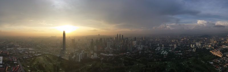 High angle view of modern buildings against sky during sunset