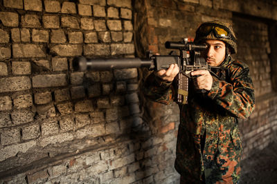 Portrait of man standing against wall