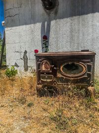 Abandoned vintage car against wall