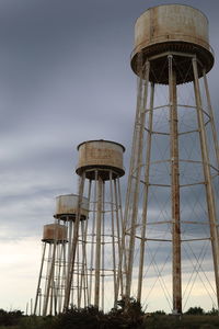 Water towers at the sunflower ammunition plant with a storm rolling in