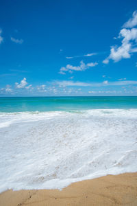 Scenic view of beach against blue sky