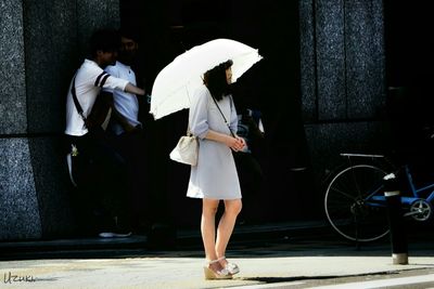 Full length of woman standing by railing