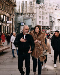 Women walking on street in city during winter