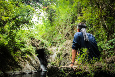 Full length of man standing in forest