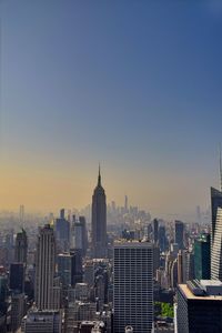 Buildings in city against clear sky