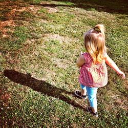 Girl standing on grassy field