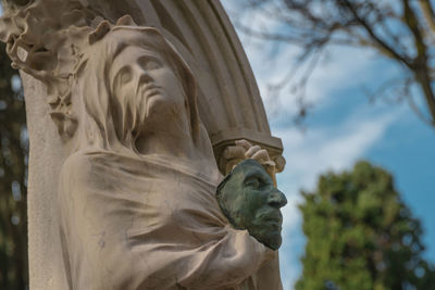 Low angle view of statue against sky