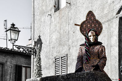 Woman in  venetian costume on balcony