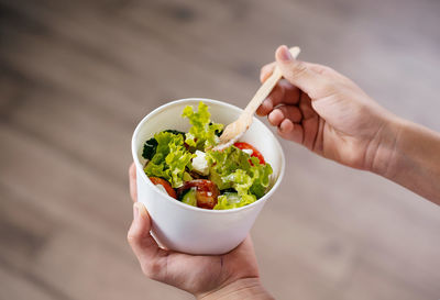 Cropped hand of person holding food