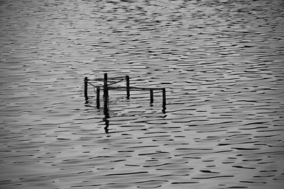 Full frame shot of wooden posts in lake