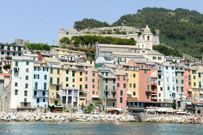 Buildings in city against clear sky