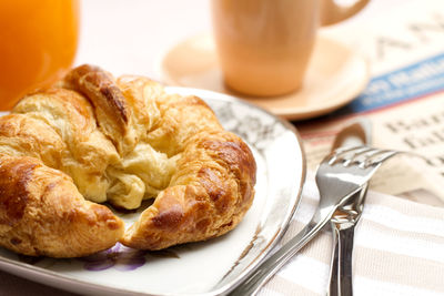 Close-up of croissant in plate on table