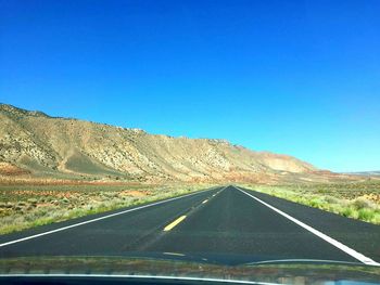 Empty road along countryside landscape