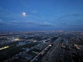 High angle view of city lit up at night