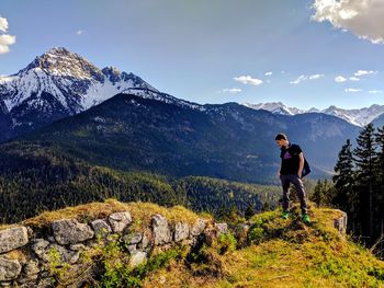 Full length of man standing on mountain against sky