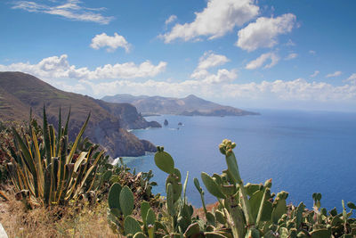 Scenic view of sea and mountains against sky