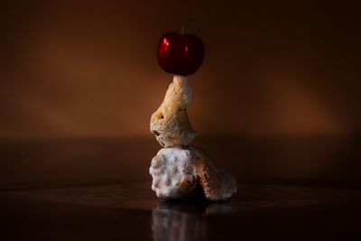 Stack of cherry and seashells on table