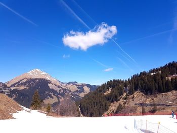 Scenic view of mountains against blue sky